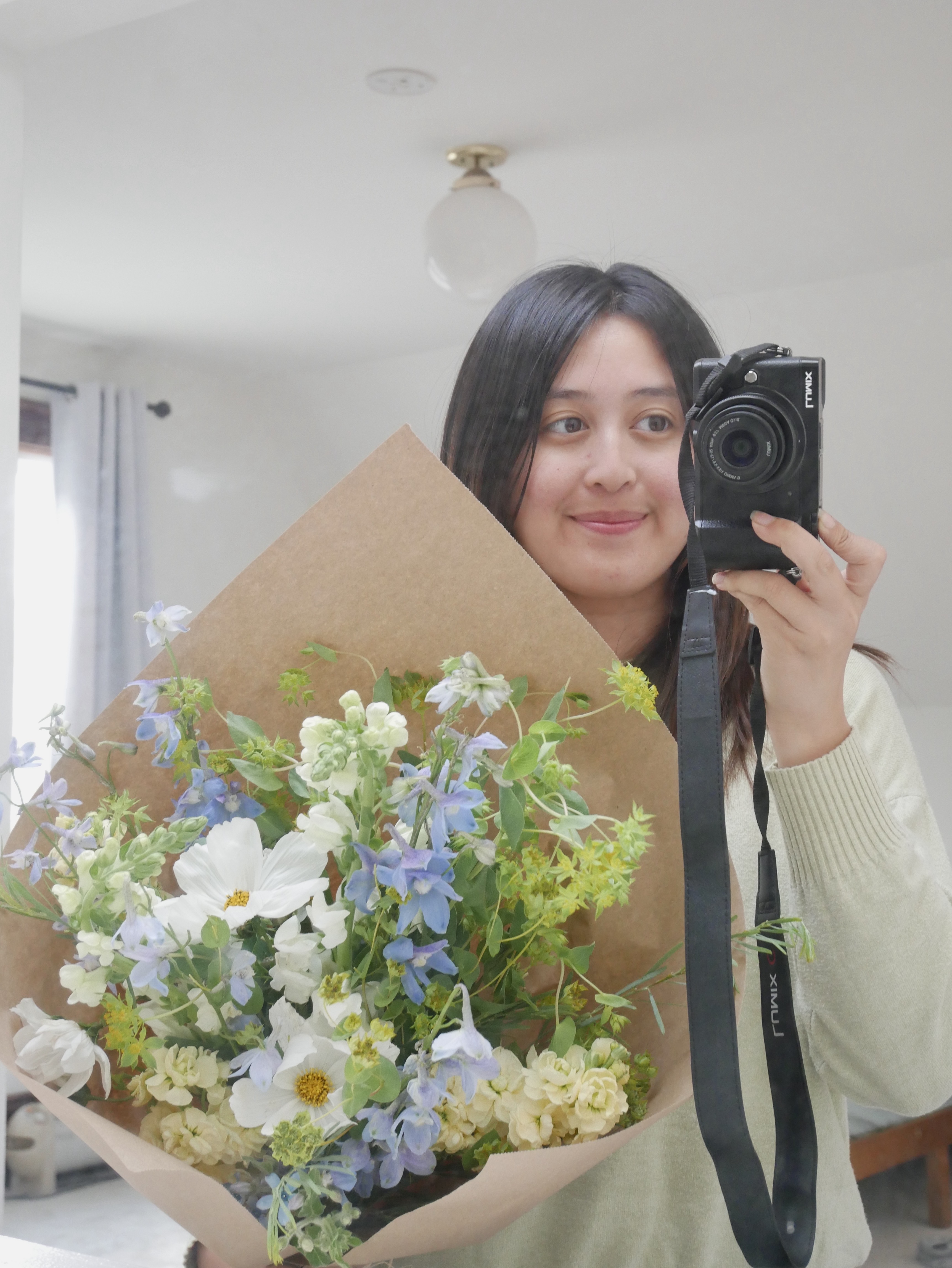 Studio portrait of Morgan holding a bouquet